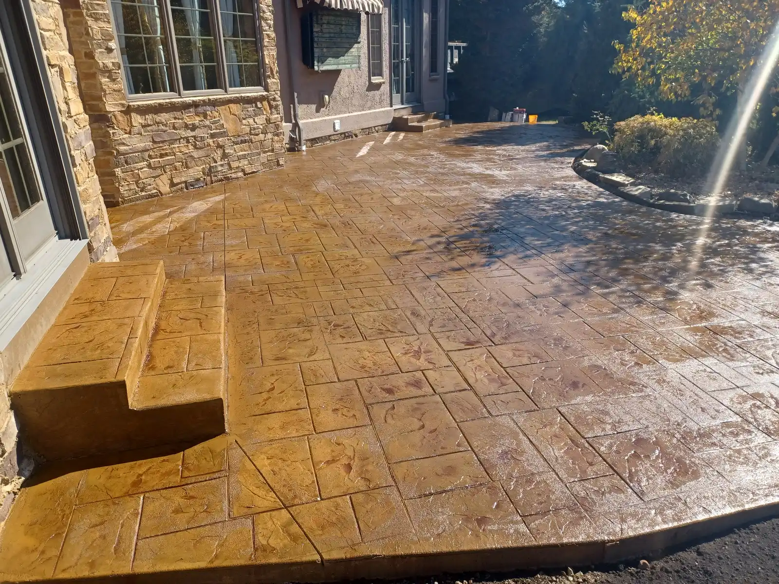 Stamped and stained concrete patio completed by Mattucci Construction — real jobsite photo showing finished craftsmanship, unedited