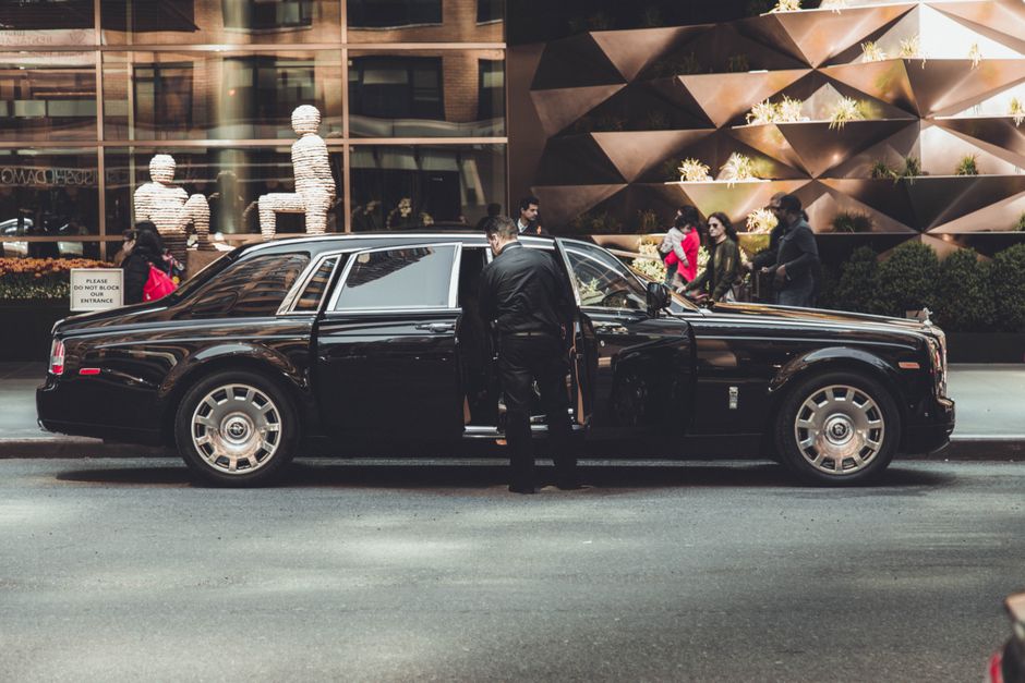 Professional services | Premier Private Rides professional chauffeur opening a luxury vehicle door